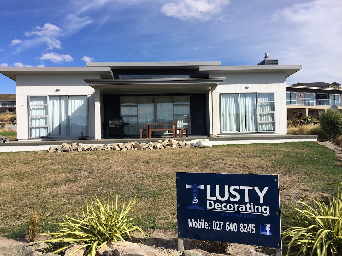 Completed coastal home repaint with Lusty Decorating signage