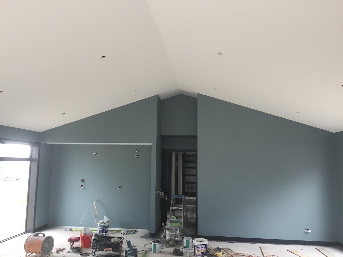 Interior repaint in progress with blue grey feature walls